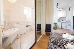 a bathroom with a tub and a bed and a sink at Deluxe Prince Machabeli Suite in Tbilisi City +19 photos