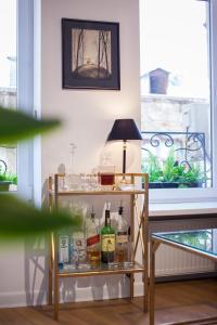 a shelf with alcohol bottles and a lamp on a window at Deluxe Prince Machabeli Suite in Tbilisi City