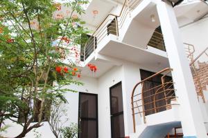 a white house with a staircase and flowers at El Mirador in Tarapoto