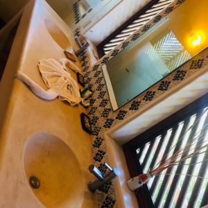 a view of a bathroom with a mirror and a window at Hotel Bella vista in Zihuatanejo