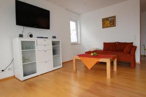 a living room with a couch and a table at Mühlgarten in Immenstaad am Bodensee