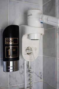 a hair dryer and a hair washer in a bathroom at Budget Trianon Hotel in Amsterdam