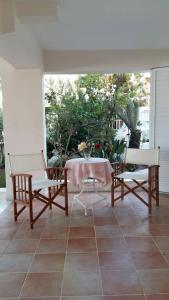 a patio with two chairs and a table on a patio at NN Luxury Room near Athens Airport in Spata