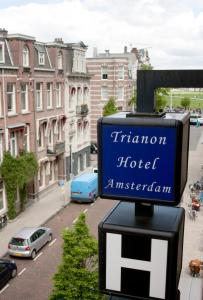 a sign for a hotel on a city street at Budget Trianon Hotel in Amsterdam