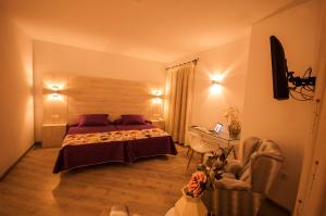 1 dormitorio con cama, silla y escritorio en Hotel Hc Zoom, en Pozoblanco