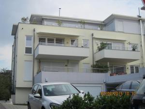 a white car parked in front of a building at Mühlgarten in Immenstaad am Bodensee