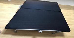 a black bed sitting on top of a wooden floor at 220 Kouri Nakijin-son - Hotel / Vacation STAY 8713 in Nakijin