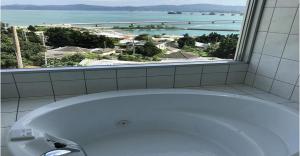 a bath tub in a bathroom with a large window at 220 Kouri Nakijin-son - Hotel / Vacation STAY 8716 in Nakijin
