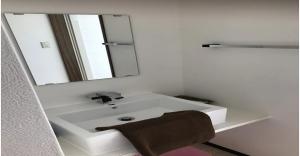 a bathroom with a white sink and a mirror at 220 Kouri Nakijin-son - Hotel / Vacation STAY 8717 in Nakijin