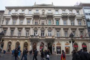 a large building with people walking in front of it at Knez Mihailova Apartman in Belgrade