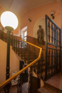 a statue of a man sitting on the stairs of a building at Knez Mihailova Apartman in Belgrade