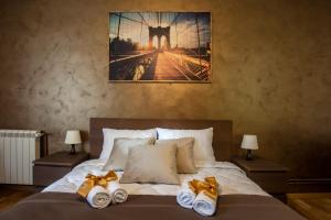 a bedroom with a bed with two towels on it at Knez Mihailova Apartman in Belgrade