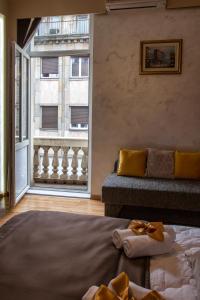 a living room with a couch and a large window at Knez Mihailova Apartman in Belgrade
