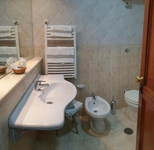 a bathroom with a sink and a toilet at Grand Hotel Pavone in Cassino