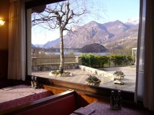 a window with a view of a mountain view at Hotel La Solitaria in Carlazzo +9 photos