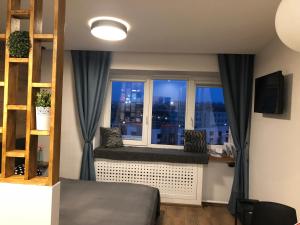 a bedroom with a window with a view of a city at K&P Apartment in Vilnius