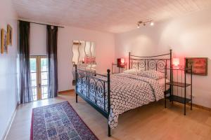 a bedroom with a bed with a wrought iron frame at Chateau de la Grange in Saint-Émiland
