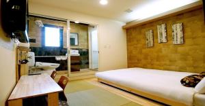 a bedroom with a bed and a bathroom with a sink at 41-2 Surugamachi - Hotel / Vacation STAY 8334 in Nara