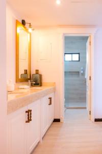 a bathroom with a sink and a mirror at Casa Barco Hotel Boutique in Isla Mujeres