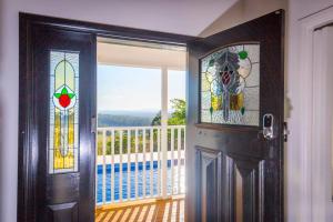 a door with stained glass windows in a room with a balcony at Montana in Mount View