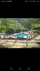 a group of wooden benches sitting in a field at Cabañas rurales la vega in Burunchel +17 photos