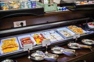 a buffet line with different types of food on display at Boutique Hotel Golden Star in Tuzla