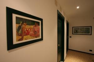 a painting on the wall of a room with a picture on the wall at Albergo Adriana in Celle Ligure