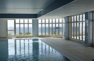 a swimming pool in a building with windows at Residence Reine Marine in Saint Malo