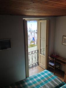 a bedroom with a door open to a balcony at Albergo Il Vapore in Menaggio