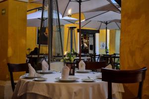 a table with plates and napkins on it in a restaurant at Los Camilos in Mexico City