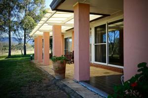 una veranda di una casa con patio di Verona Vineyard Cottage a Pokolbin