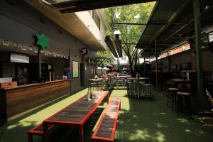 a restaurant with wooden tables and chairs and a bar at Beer Deluxe Albury in Albury