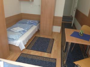 a bedroom with a bed and a desk at Hotel Prim in Bratislava