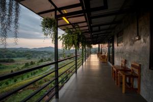 a building with a balcony with a view at Ob-Oon Khao Kho Resort in Khao Kho