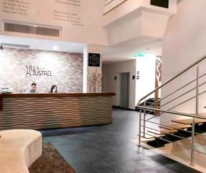 a lobby of a restaurant with a counter and stairs at Lam Hotel Villa Aljustrel in Aljustrel