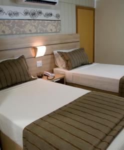 Cama ou camas em um quarto em BH Jaraguá Hotel