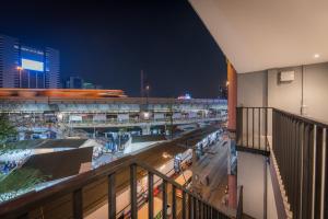 a view of a shopping mall at night at Yello Rooms Hotel Victory Monument in Bangkok