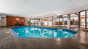 a large swimming pool in a building with windows at Best Western Laval-Montreal & Conference Centre in Laval