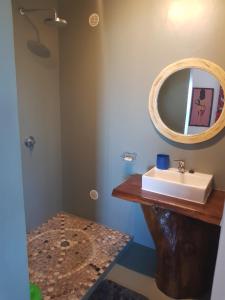 a bathroom with a sink and a mirror at Villa océane in Tôlagnaro +16 photos