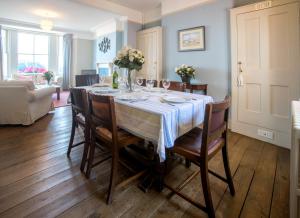 a dining room with a table and chairs at 14 Market Cross Place - Beachfront location with lovely sea views - Aldeburgh Coastal Cottages in Aldeburgh