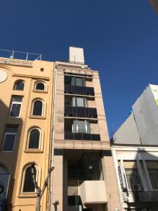 a tall building with a blue sky in the background at ROSE ROOM in Fukuyama