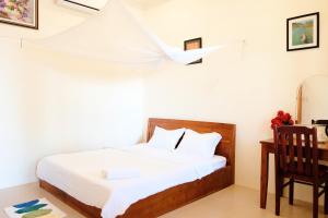 A bed or beds in a room at The Palm Tree Guesthouse