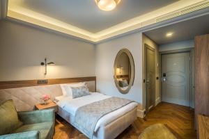 
a bedroom with a large bed and a large mirror at Hotel Vilnia in Vilnius
