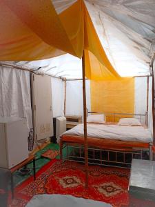 a bedroom with a bed in a tent at Nature Trail camps & Homestay in Jodhpur