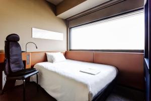 Postel nebo postele na pokoji v ubytování remm Shin-Osaka