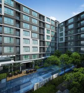 a large apartment building with a garden in front of it at D Condo Nernpra Rayong in Rayong