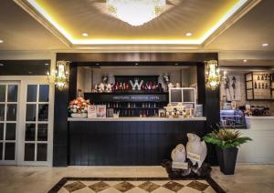 a bar in a hotel lobby with a counter at Westgate Residence Hotel in Ban Bang Kho