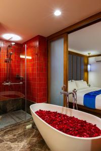 a bathroom with a bath tub filled with red roses at Lavana Hotel Chiangmai in Chiang Mai