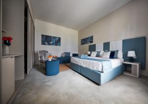 a bedroom with a large bed and a couch at VOI Marsa Siclà Essentia in Sampieri