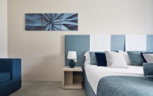 a bedroom with two beds and a table with a lamp at VOI Marsa Siclà Essentia in Sampieri